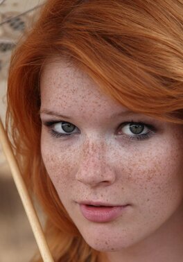 Ginger babe thinks nobody will see her naked under the umbrella in the park