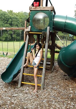 Brunette with pigtails and skinny legs does inappropriate things by green slide