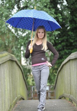 Charming blonde schoolgirl poses totally naked while hiding from rain