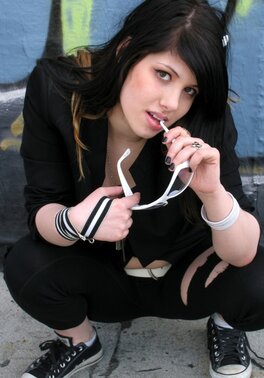 Fetish doll spreads legs and poses naked in alleyway with sunglasses