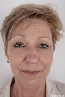 Mature porn model with tattooed shoulder advertises natural twins ...