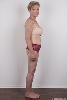 Mature porn model with tattooed shoulder advertises natural twins ...