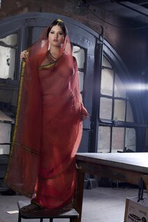 Diva in a transparent red sari fails to hide her big melons with ...