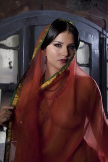 Diva in a transparent red sari fails to hide her big melons with ...