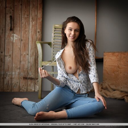 Beautiful brown-eyed teen takes off shirt and jeans at the photo session