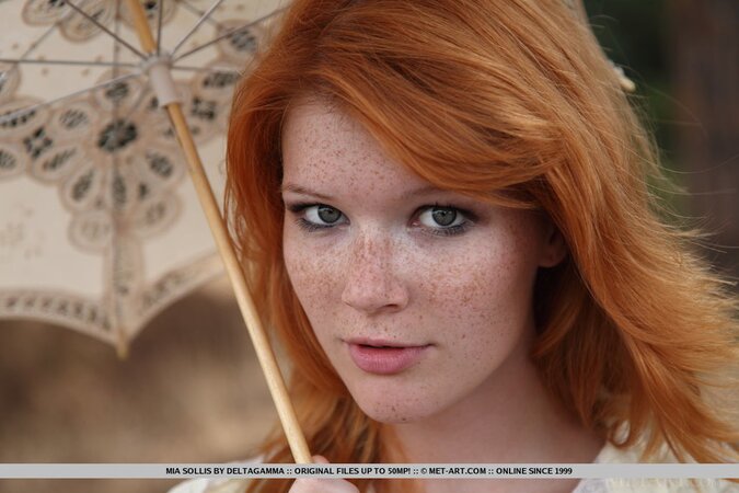 Ginger babe thinks nobody will see her naked under the umbrella in the park