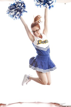 Funny red-haired high-school cheerleader Penny Pax strips while dancing