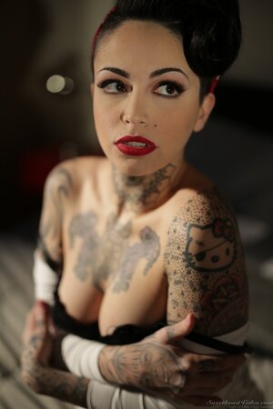 Inked brunette has enough talent to pose naked in image of pinup model