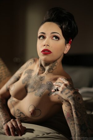 Inked brunette has enough talent to pose naked in image of pinup model