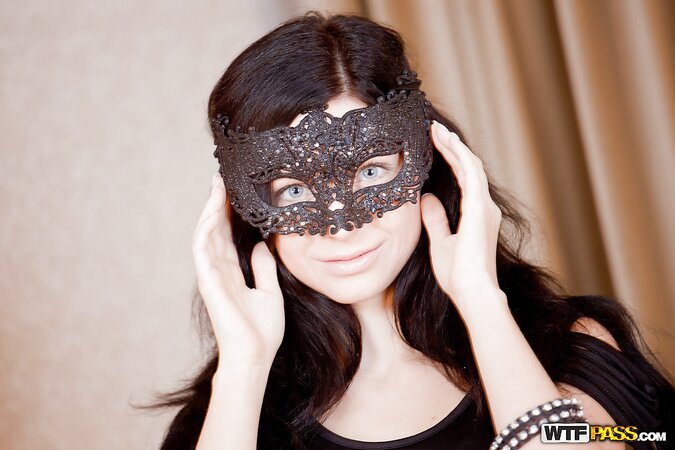 Mysterious blue-eyed brunette in bizarre panties and black mask poses on camera