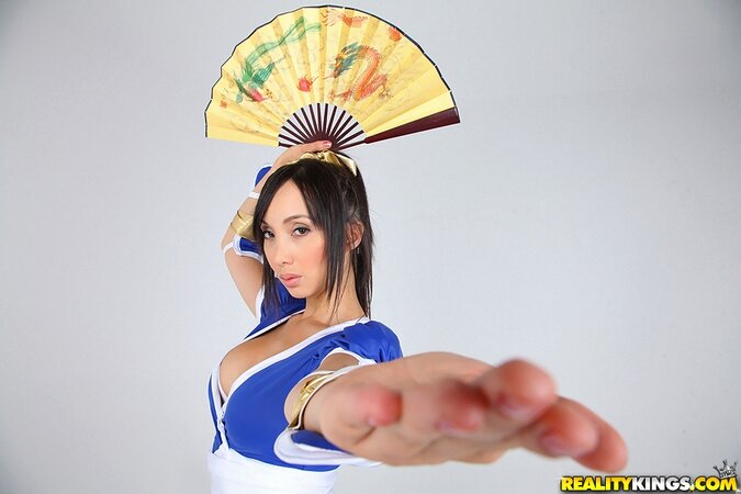 Cosplay photo session of Asian model with big boobs, samurai's saber, and fan