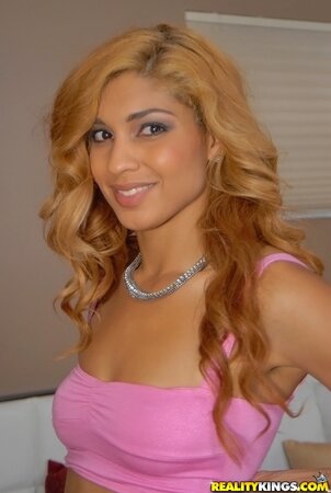 Latina angel in pink top and black skirt is in mood to show her assets