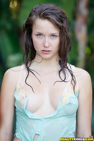 Enticing cutie with perky tits seductively poses outdoors after rain