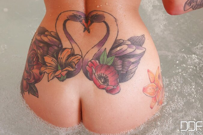 Tattooed Daniella Mae with attractive boobs gets in a bathtub to wash her body