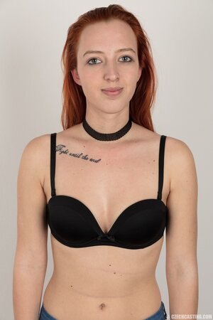 Pale chick with red hair unveils small breasts but doesn't take black panties off
