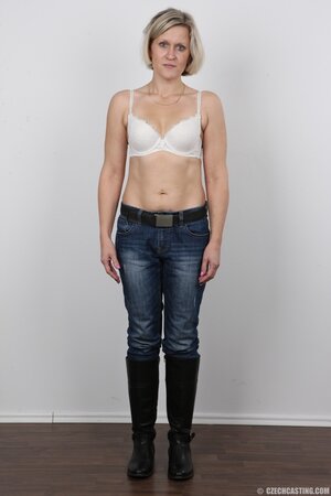 Blonde mature woman in jeans and white lingerie doesn't protect her privacy