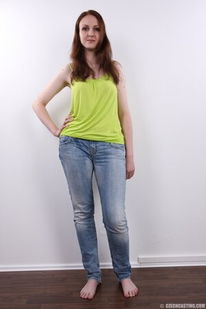 Amateur girl wears green top and blue jeans but finally takes all off