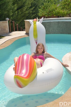 Female is lying on inflatable unicorn in pool and then makes man sneak into pussy
