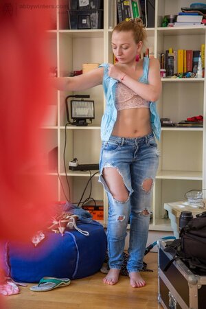 Small-boobied Virginee Spice pulls on jeans and small top after posing nude