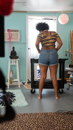 Arousing black girl with fat butt cheeks and fuzzy hair wears tight clothes
