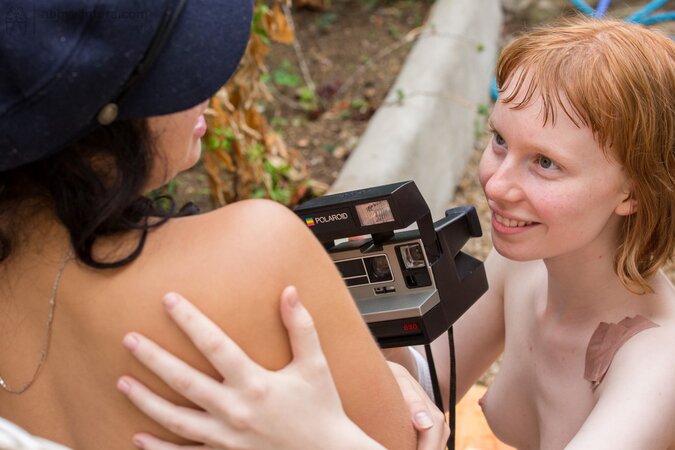 Young redhead dyke seduces friend for an outdoor lesbian sex on the rattan sofa