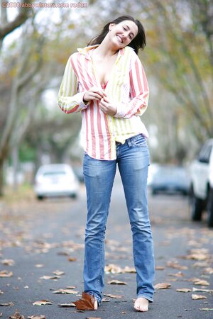 Teen in striped shirt and jeans walks the streets and strips on the move