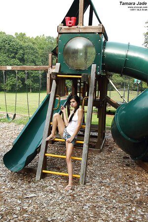 Brunette with pigtails and skinny legs does inappropriate things by green slide