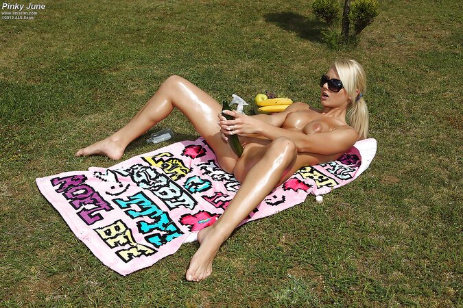Eccentric blonde masturbates with cucumber while relaxing outdoors on the lawn