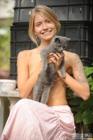 Skinny blonde wakes up and goes in the garden to play with her pretty cat