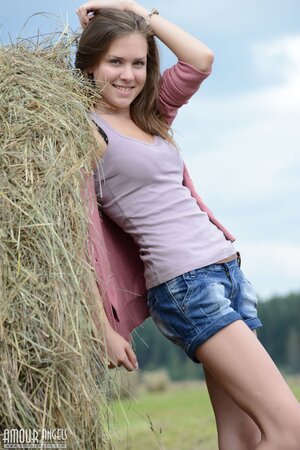 Near stack of hay good-looking teen decides to relax fully naked under the sun