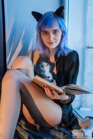 Shy alt girl while sitting near window seductively demonstrates tits and pussy