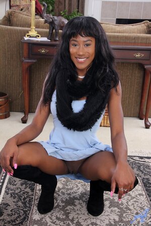 Smiling black girl leaves nothing on to finger her muff on the carpet