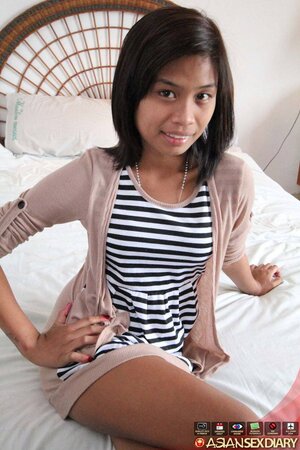 Cute Asian girl takes off a striped dress in exchange for some money