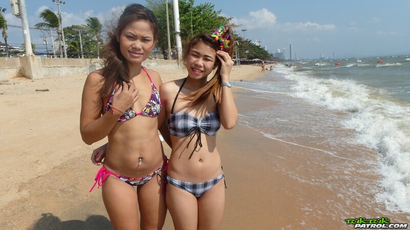 Thai babes rest on a beach and pose in tight bikini flashing innie navels
