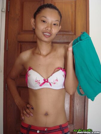 Skinny young Asian woman satisfies her sexual cravings getting naked