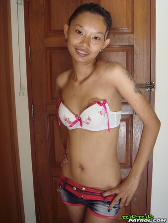 Skinny young Asian woman satisfies her sexual cravings getting naked