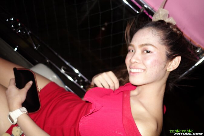 Thai slut in a red dress never stops smiling even in the backseat of a taxi