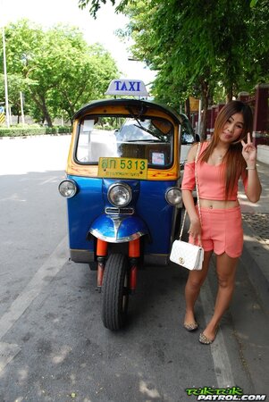 Joyful Thai minx poses near white fellow and his impressive auto rickshaw