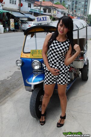 Inviting Thai model in a checkered dress gets into the Tuk Tuk Taxi