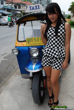 Inviting Thai model in a checkered dress gets into the Tuk Tuk Taxi