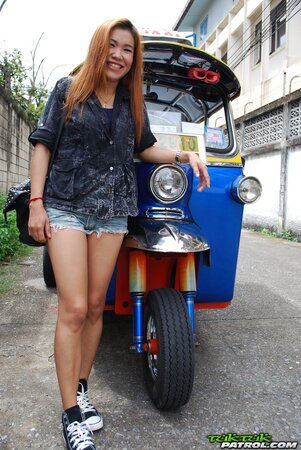 Clothed Thai girl with a cute face and red hair can brag about wonderful legs