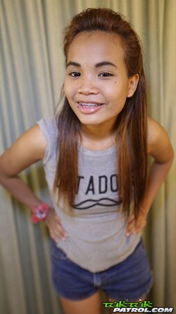 Teen Asian girl looks very cute despite the fact that she wears braces