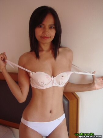 Young woman with oriental features get rid of outfit and fingers own pudenda