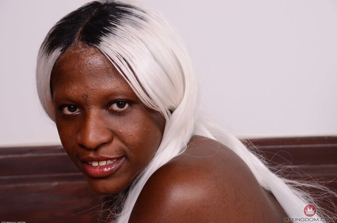 Platinum blonde woman with black skin shows how her pussy looks like