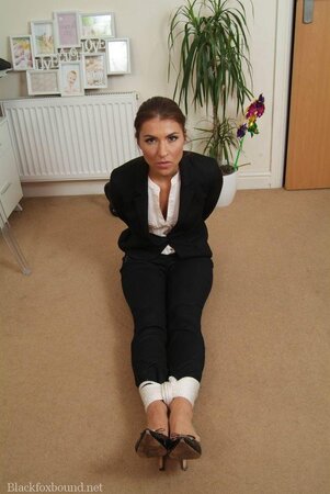 Office babe in high heels in a strict tuxedo suddenly gets tied up on the floor