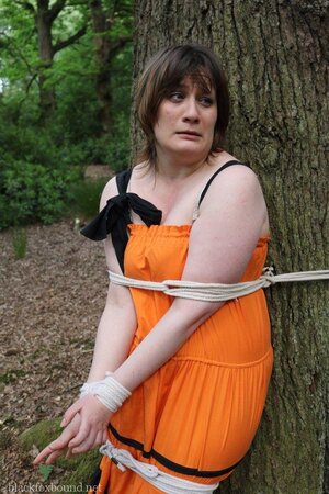 Helpless housewife is captured by lover and tied up to tree in public park