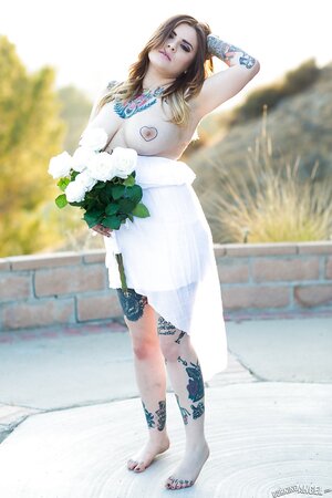 Colleen in white has a tattooed body including nipples to expose outdoors