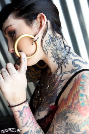 Tattooed brunette with hoop earrings shows how her smooth pussy looks like
