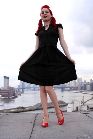 Tempting teen with red hair and high heels takes her black dress off on a roof