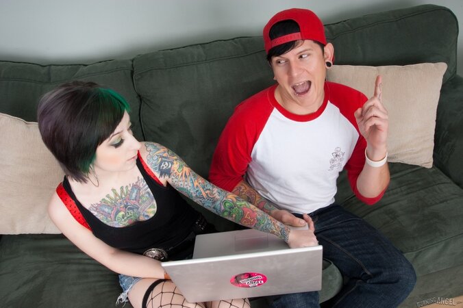 Lubricious young woman with green hair gives her tattooed body to a man
